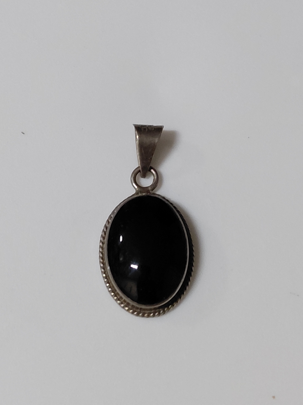 VINTAGE STERLING SILVER AND ONYX PENDANT.